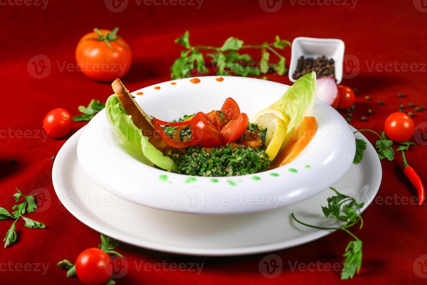 Tabbouleh Salad include bulgur wheat, tomatoes,vcucumbers combine, lemon juice and olive oi served in bowl isolated on red background top view of arabic food photo