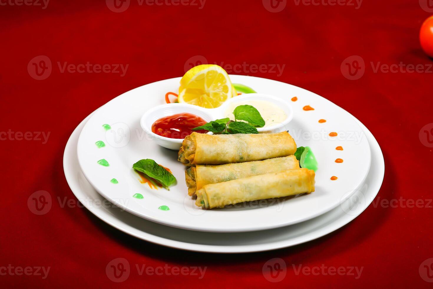 Crispy Spring Rolls with Dipping Sauces served in plate isolated on red background closeup side view of arabic food photo