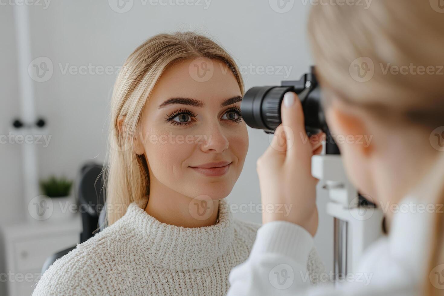 Woman undergoing an eye examination using specialized ophthalmology equipment photo