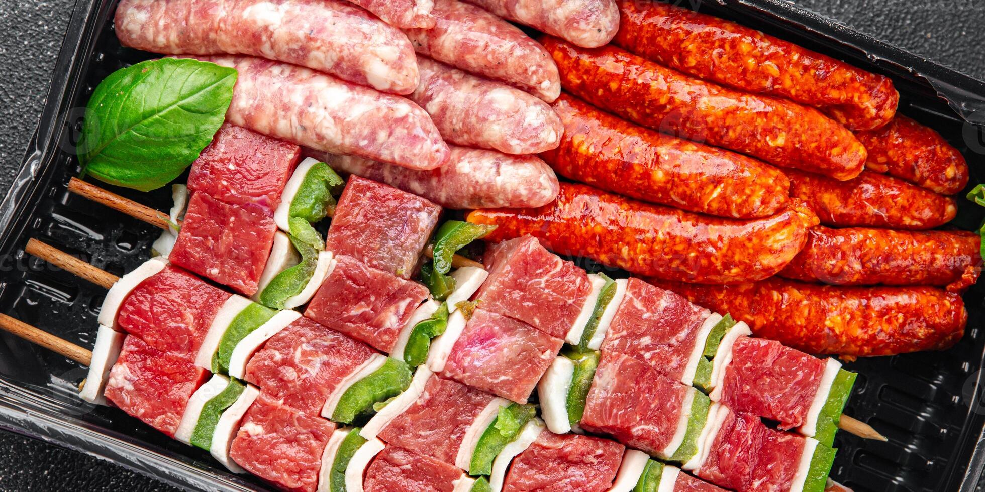 raw sausage meat assorted juicy pork, beef fresh gourmet food background on the table rustick food photo