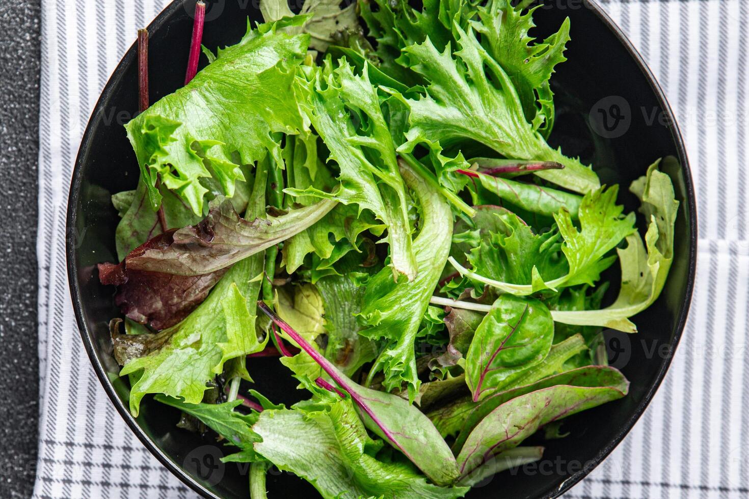 green salad bowl leaves mix fresh meal food snack on the table copy space food background rustic top view photo