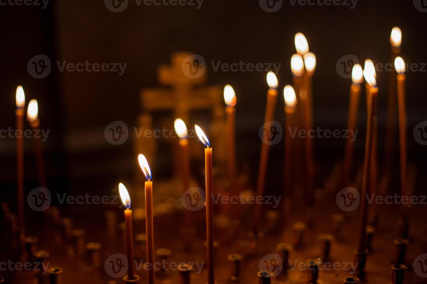 funeral memorial table place in an Orthodox church for ritual, candles are lit for repose. on a square metal table - requiem services. Christ on him with crucifixion. photo