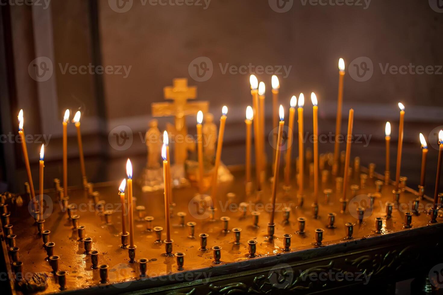 funeral memorial table place in an Orthodox church for ritual, candles are lit for repose. on a square metal table - requiem services. Christ on him with crucifixion. photo