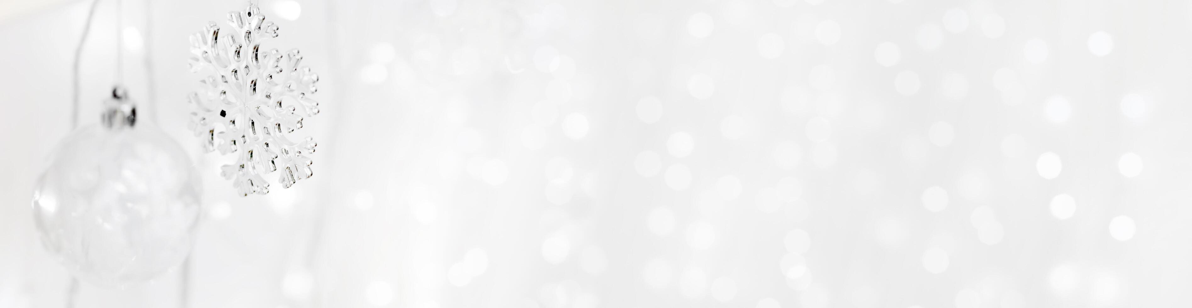 Transparent Christmas tree toy and snowflake on the background of garlands. Christmas background. Decorations for the Christmas tree. White background for new year. photo