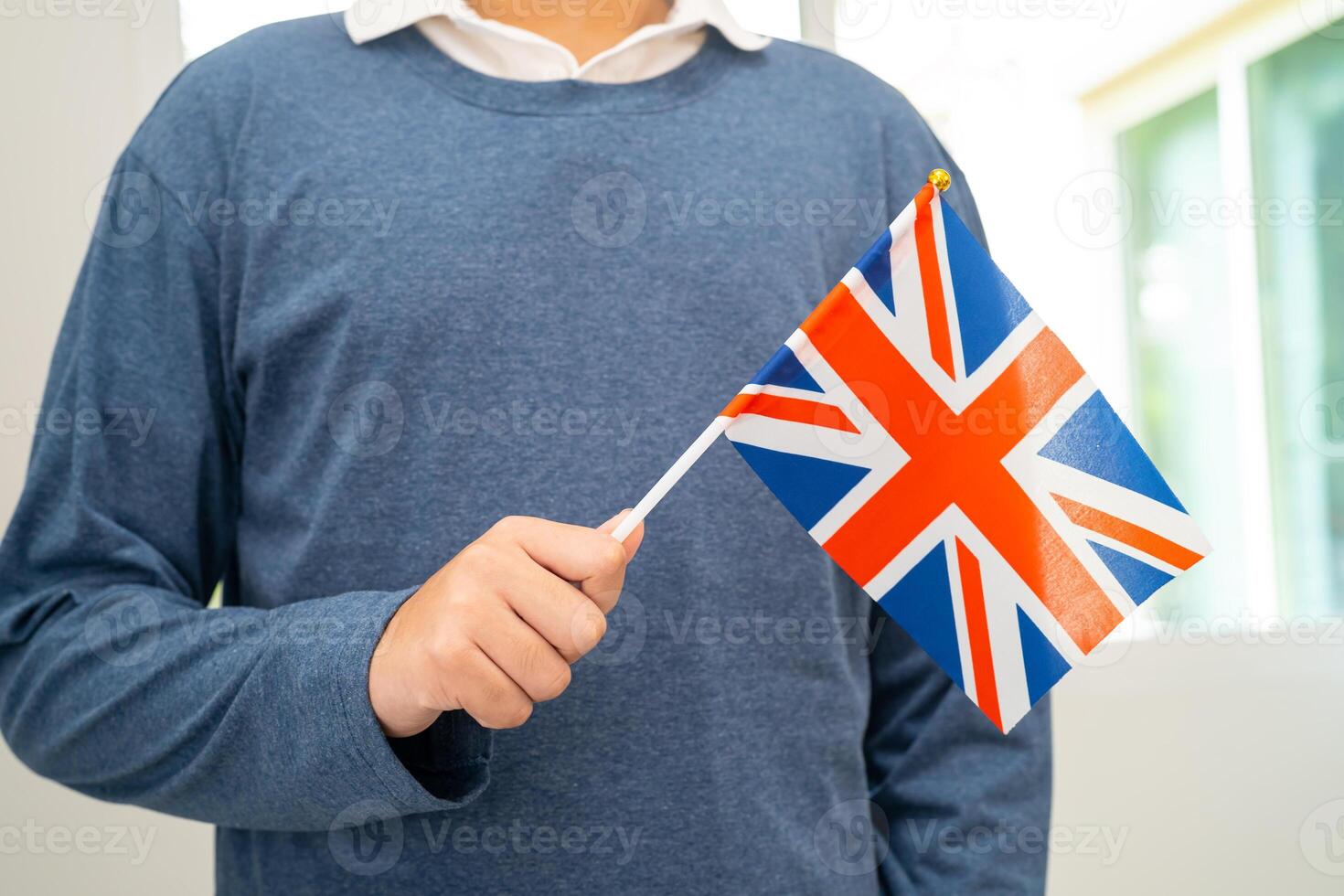 Learn English language, Asian teenage student hold UK flag in course at school. photo