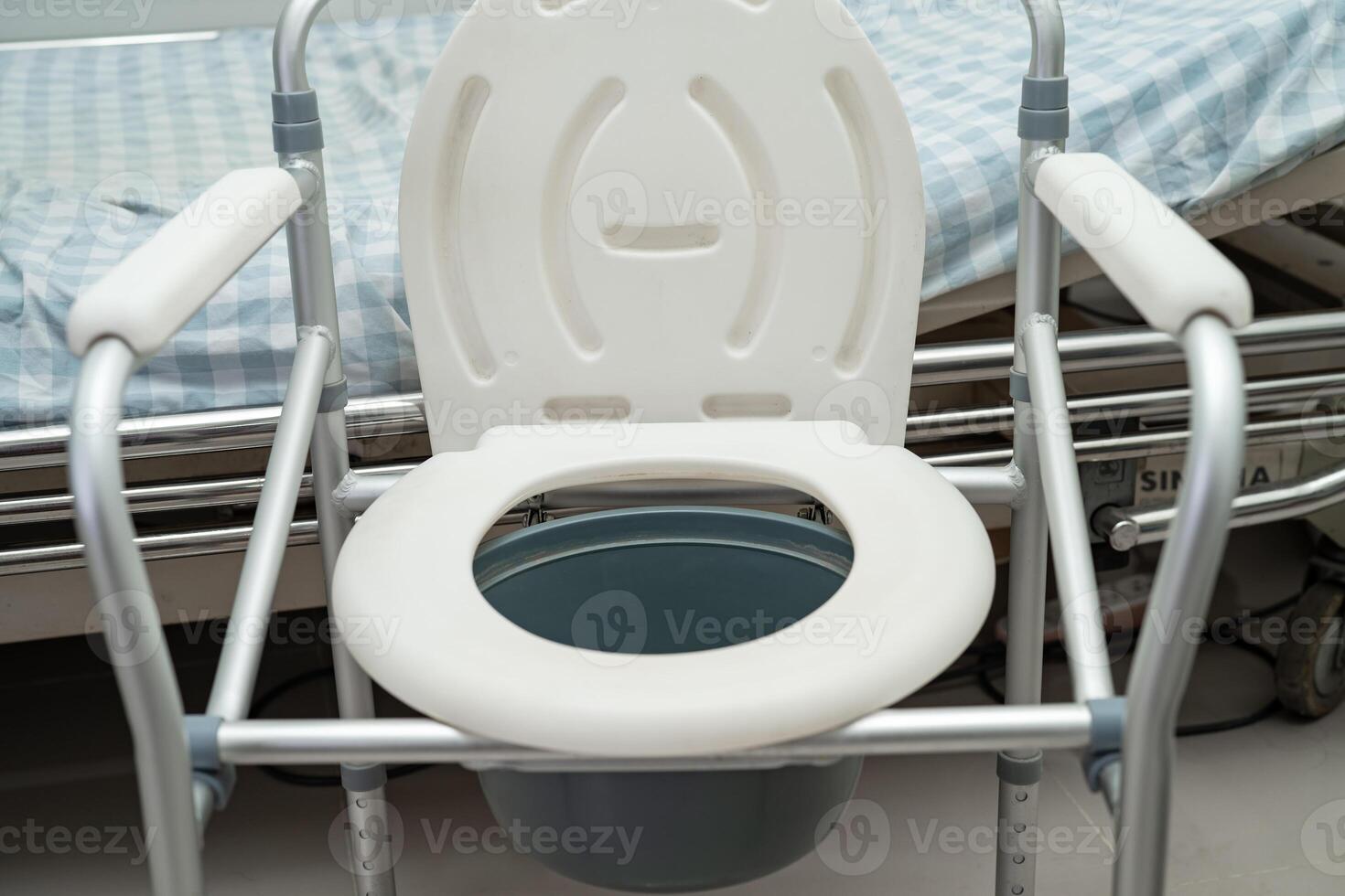 Flush toilet and shower chair in bathroom for old elder people. photo