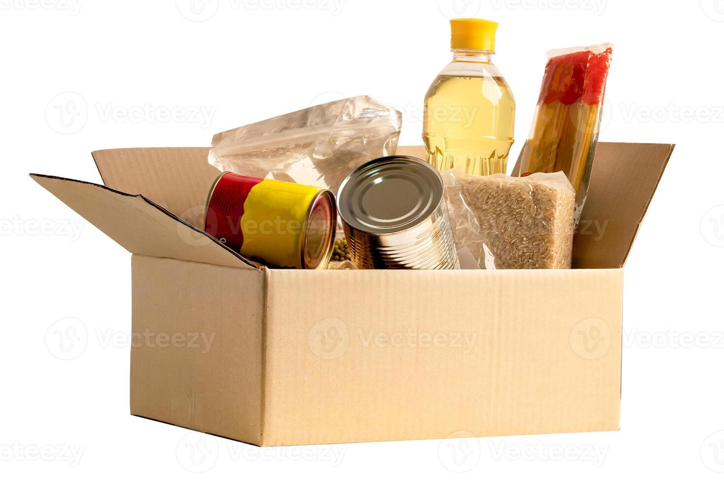 Foodstuff for donation isolated on white background with clipping path, storage and delivery. Various food, pasta, cooking oil and canned food in cardboard box. photo
