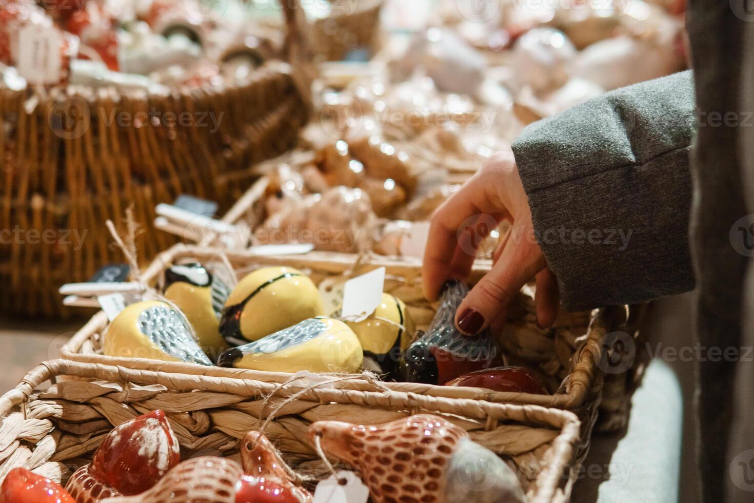 Sale of handmade ceramic Christmas tree toys at the Christmas Fair. Black Friday for the winter holidays. photo