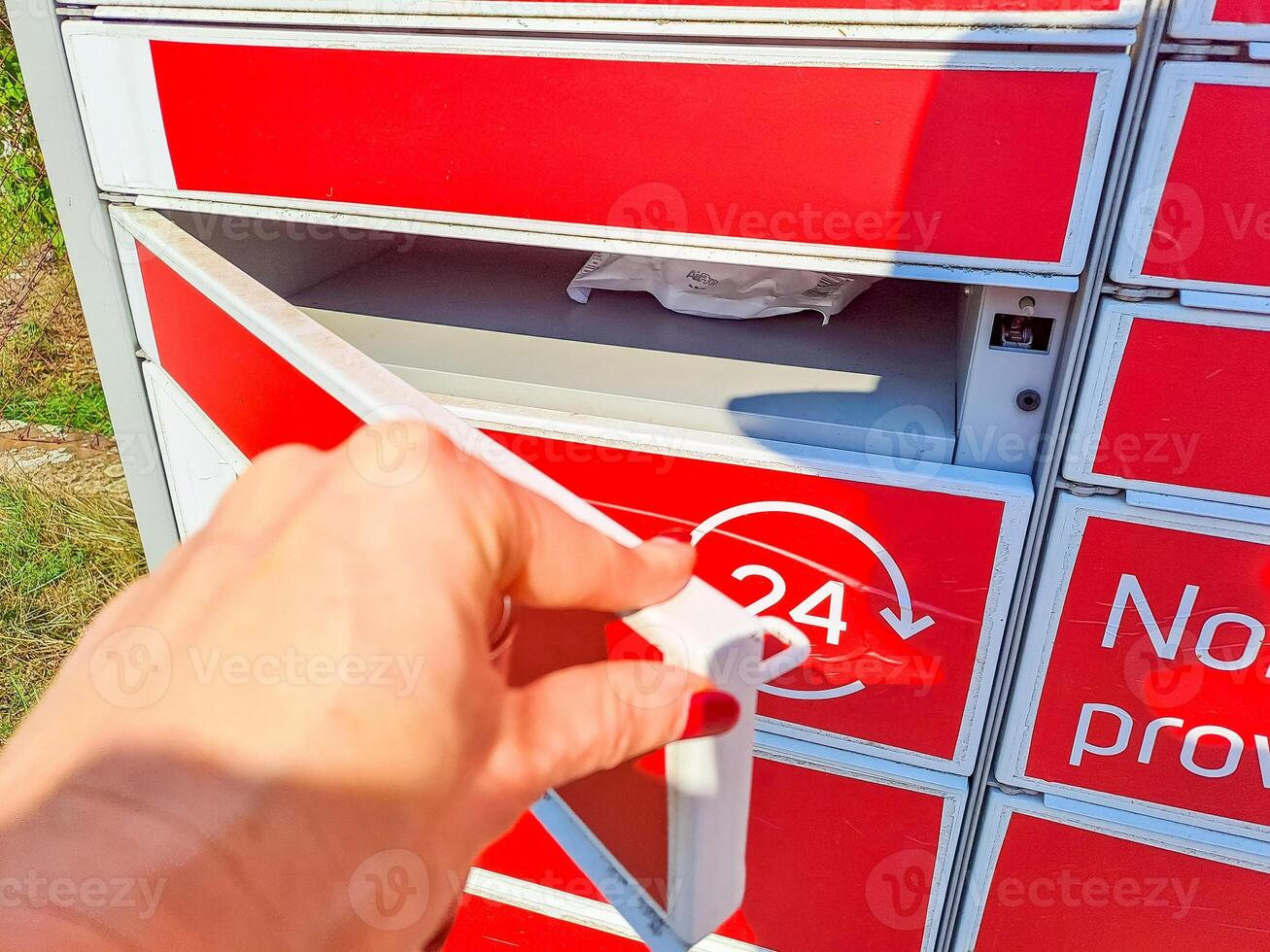 Delivery locker. Post automat terminal and hands with parcel courier box. photo