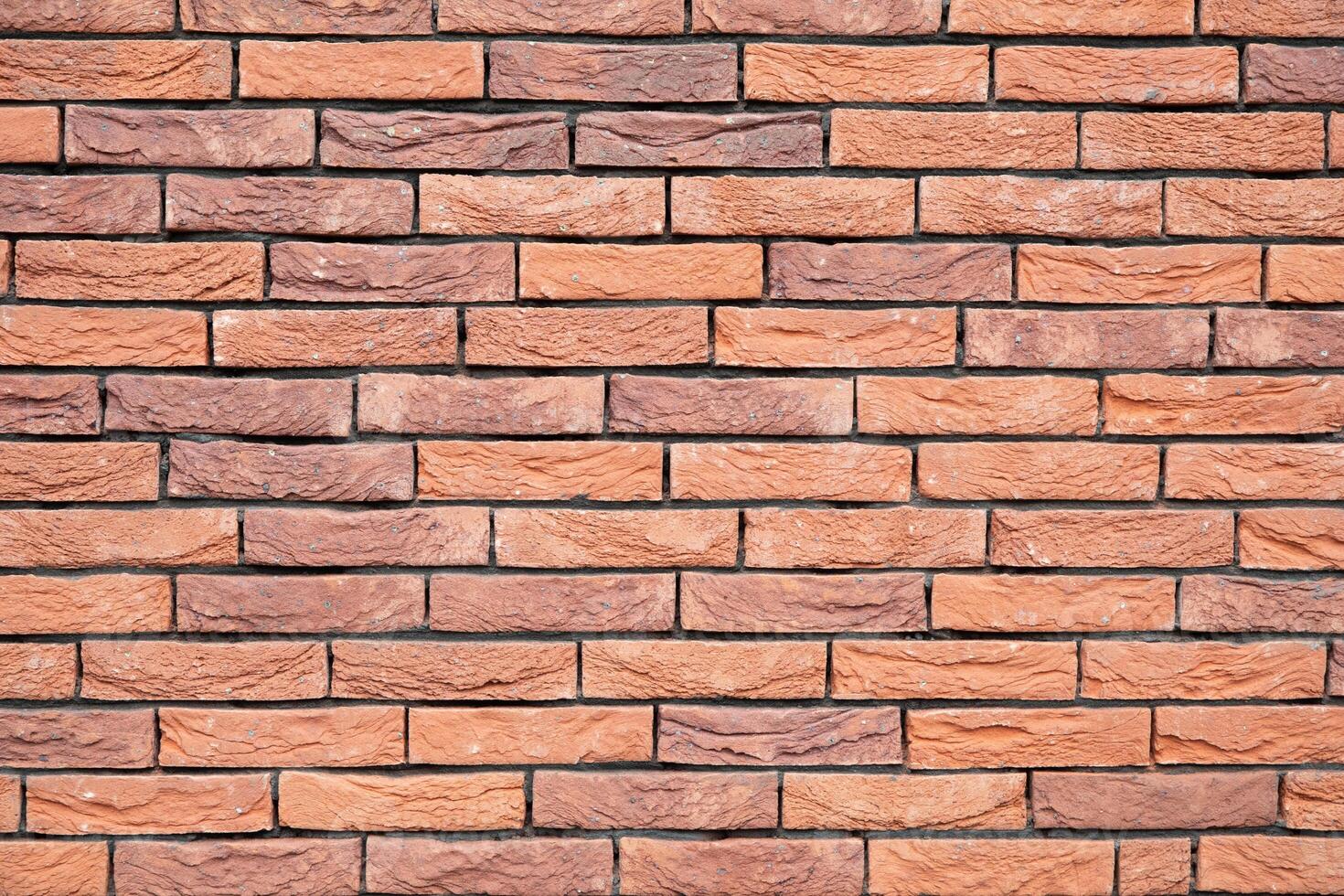 a new House is being built, the beginning of brickwork with red bricks, building materials, a pattern of stones, a natural background. High quality photo