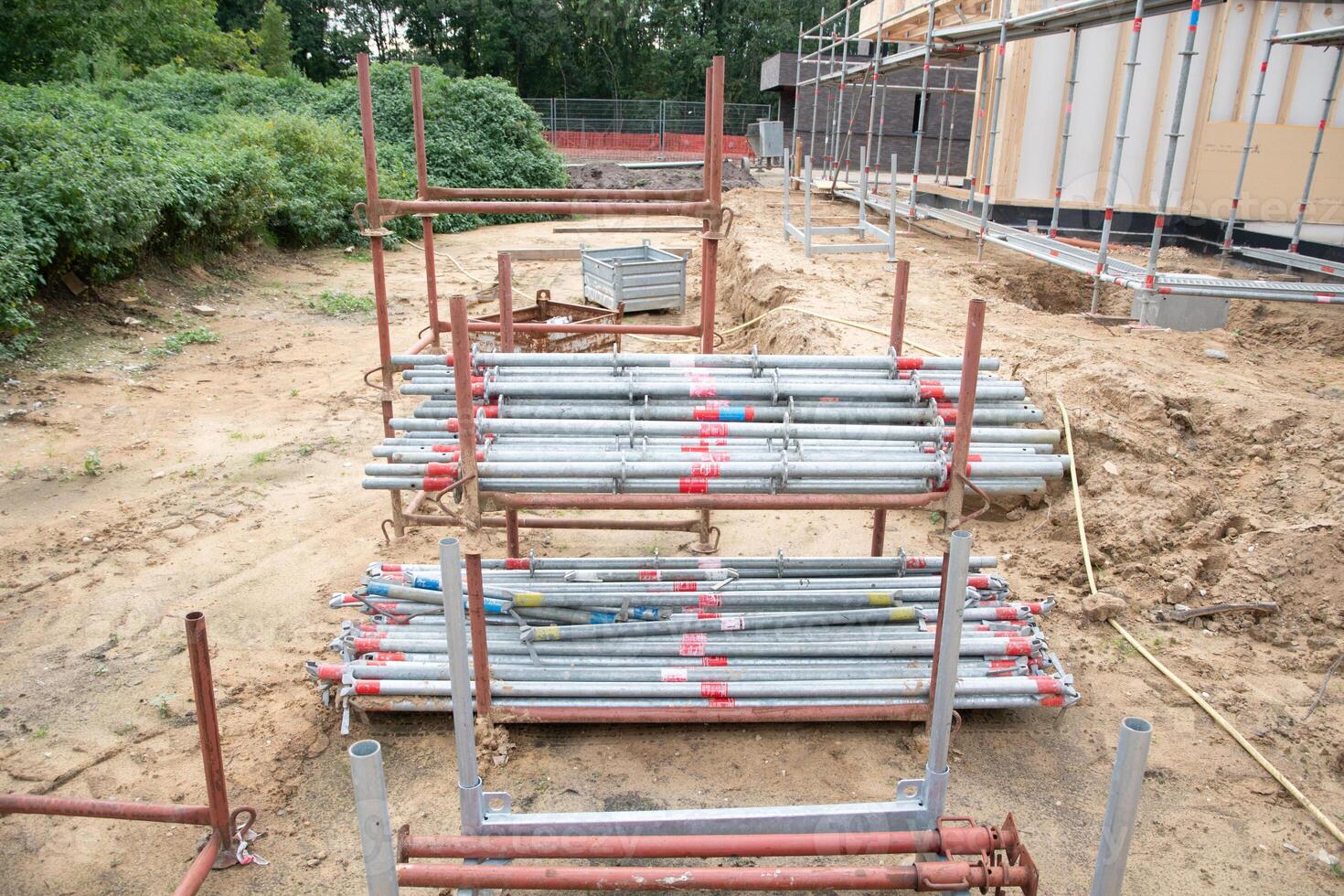 strong metal scaffolding at the construction site of a new house, the beginning of wooden structures around a metal frame. High quality photo