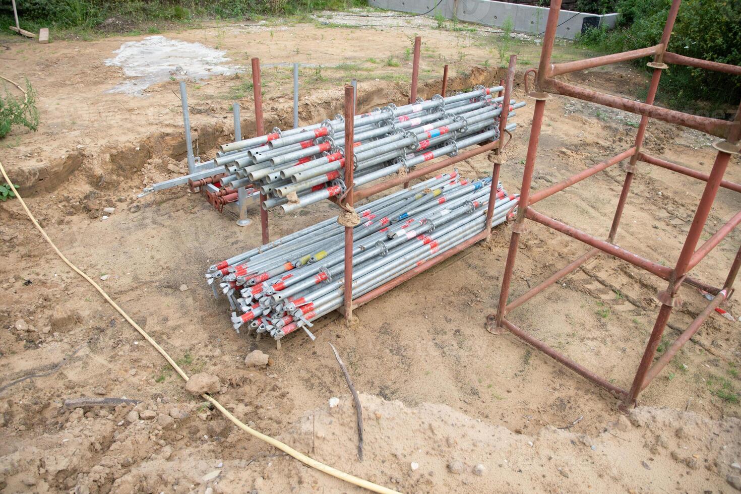 strong metal scaffolding at the construction site of a new house, the beginning of wooden structures around a metal frame. High quality photo