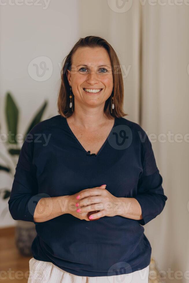 Close-up of an attractive middle aged woman smiling and looking at camera,businesswoman ,coaching photo