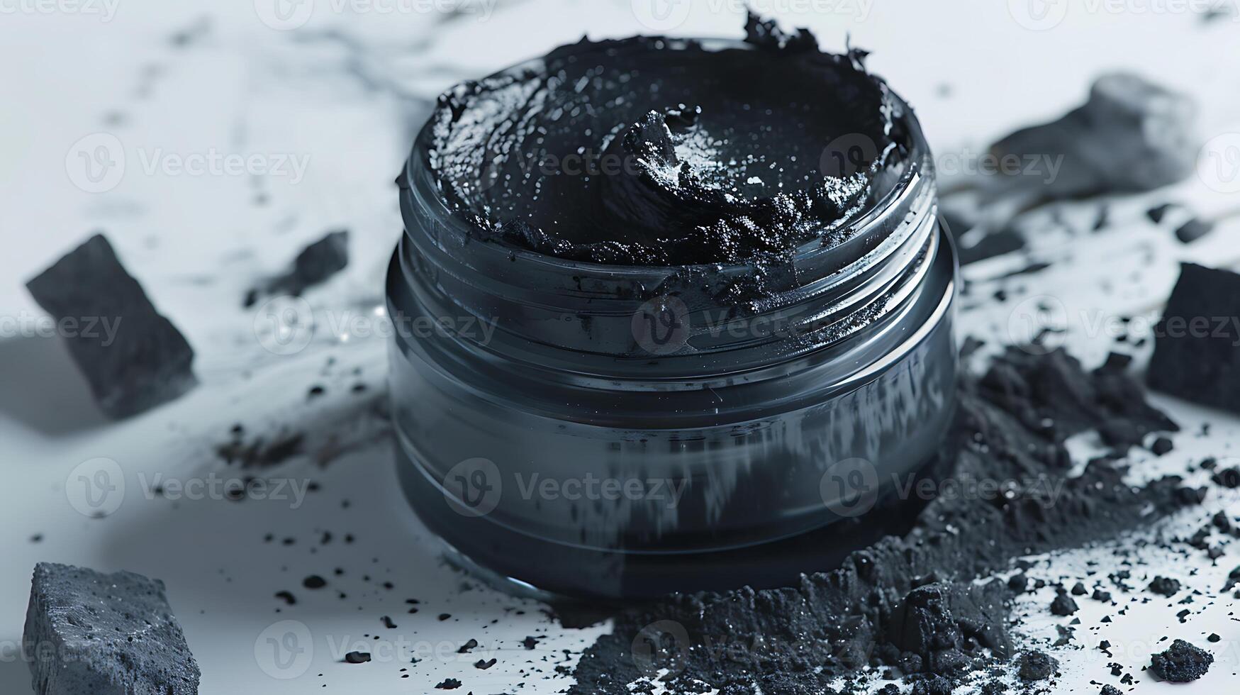 natural charcoal face scrub in a jar, showcasing activated charcoal bits on a clean white surface photo