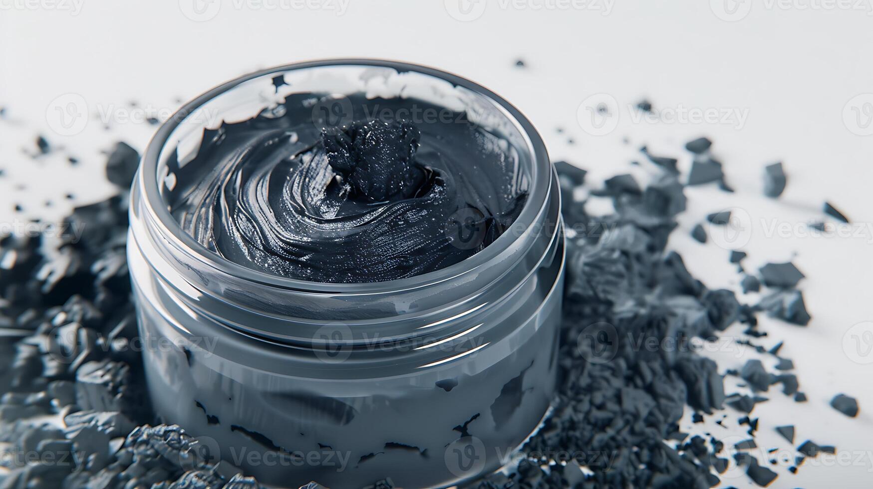 charcoal face mask in jar with activated charcoal chunks on white background. photo
