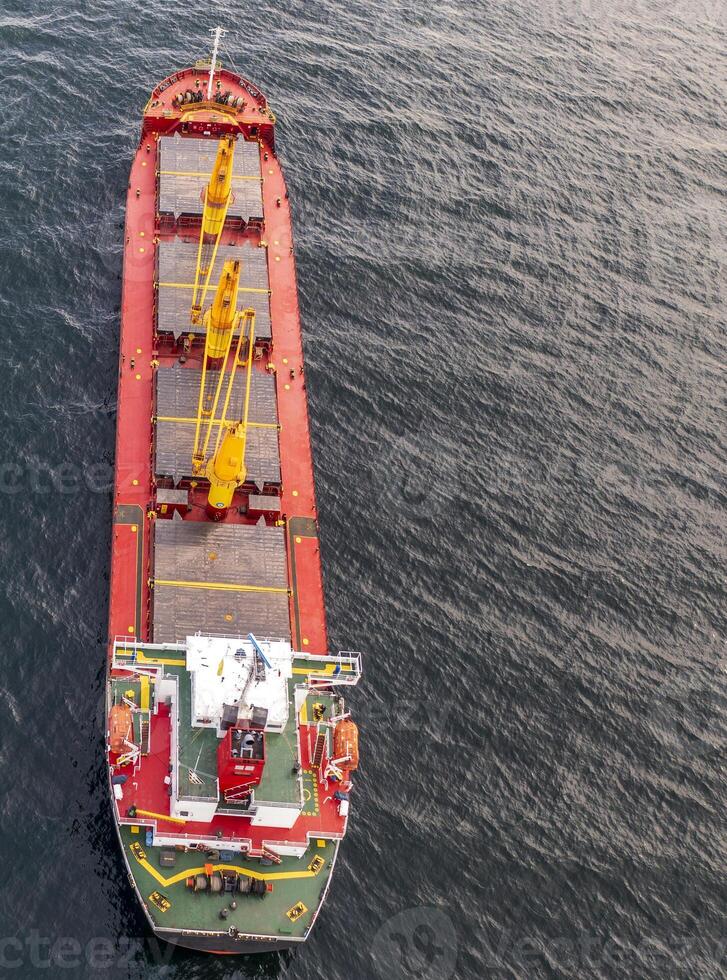 Aerial view of a container cargo ship on the sea. Cargo and shipping logistics business. Vertical view photo