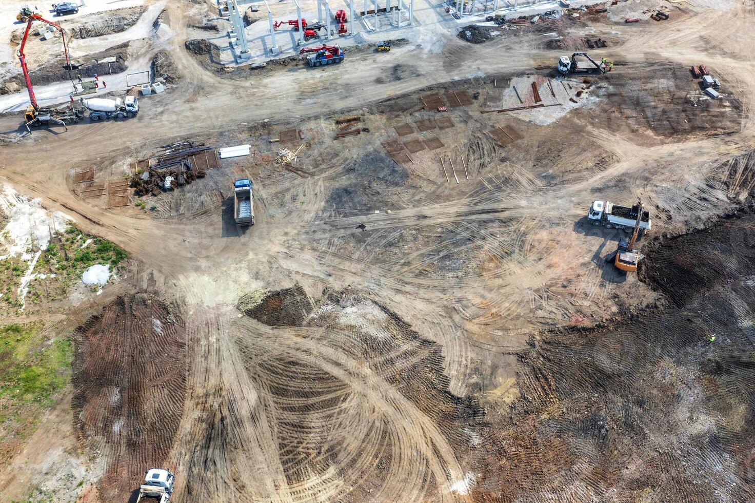 Aerial top view of big construction site with many working heavy machines photo