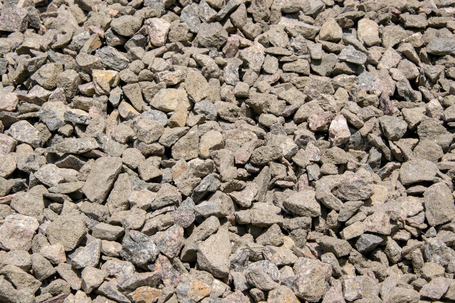 A close-up shot of a pile of gray and brown gravel stones, showing their texture and natural variation photo