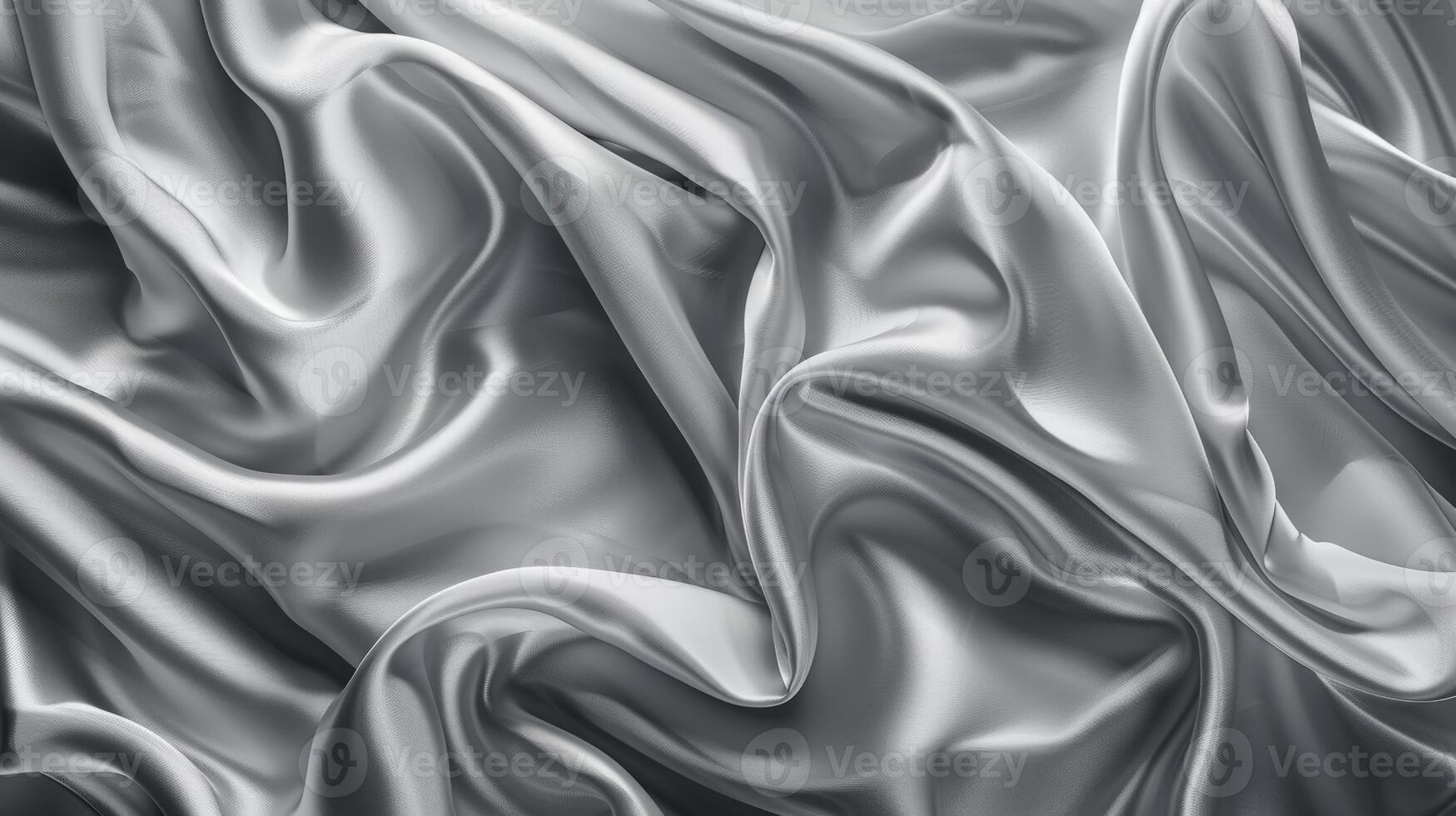 Silk satin fabrics in various shades of grey gracefully flow and curl, creating smooth, elegant textures. The soft sheen highlights the luxurious material's beauty photo