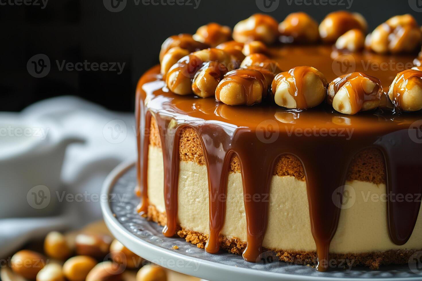 Gluten free salted caramel macadamia cake with rich caramel drizzle and nuts. photo