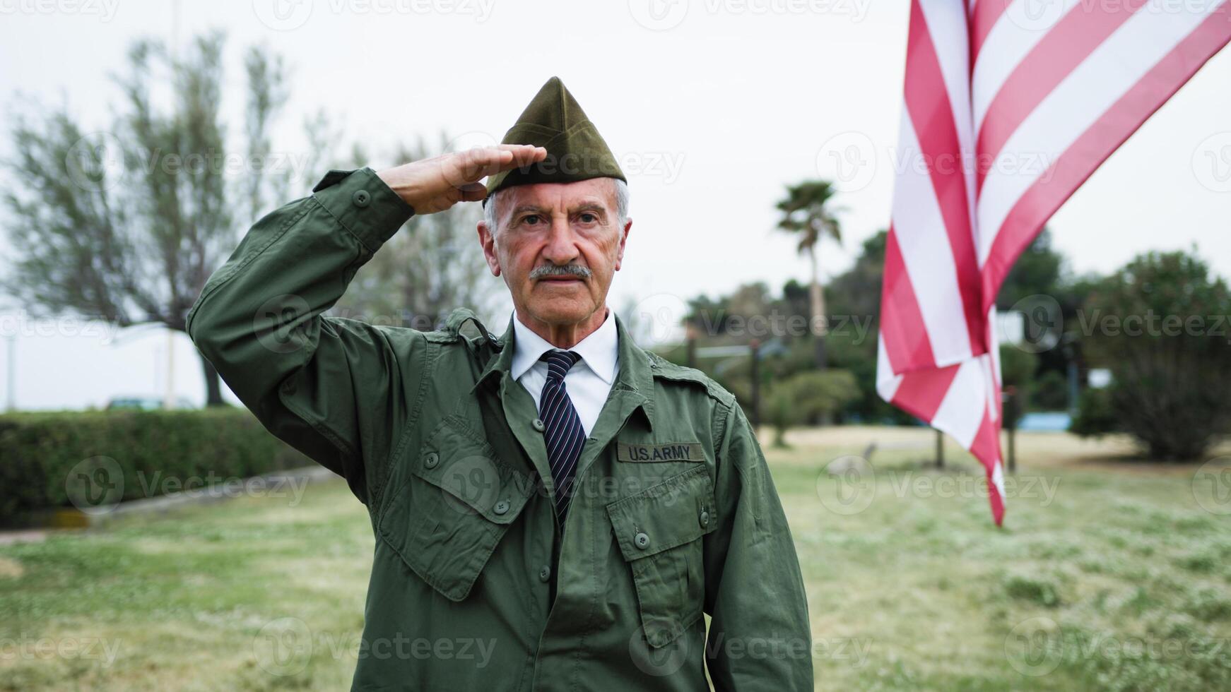 Sad Elderly Veteran Remembers Fallen In Second War at Memorial Day Cemetery photo