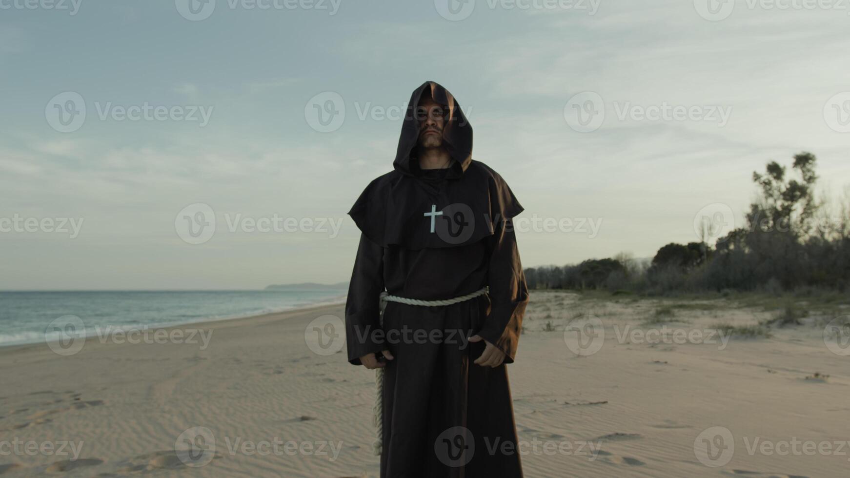 Monk Kneels On The Beach And Starts Praying photo