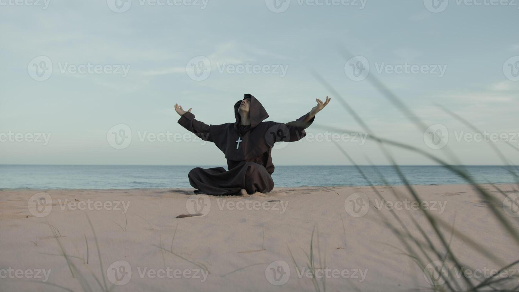 Monk Asks For Help From The Most High Almighty Sitting On The Beach In Prayer photo