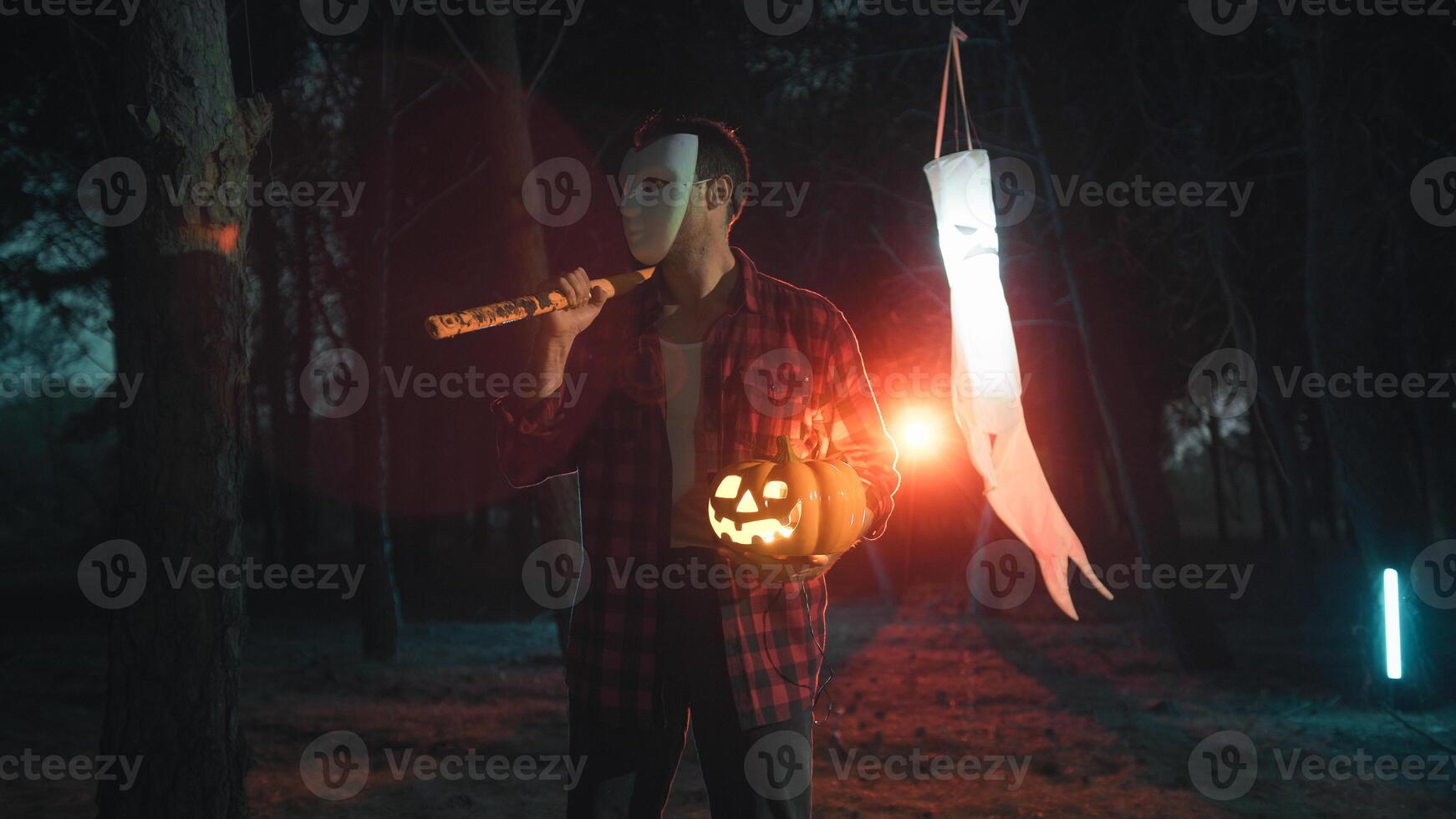 Masked man with an axe on Halloween night photo