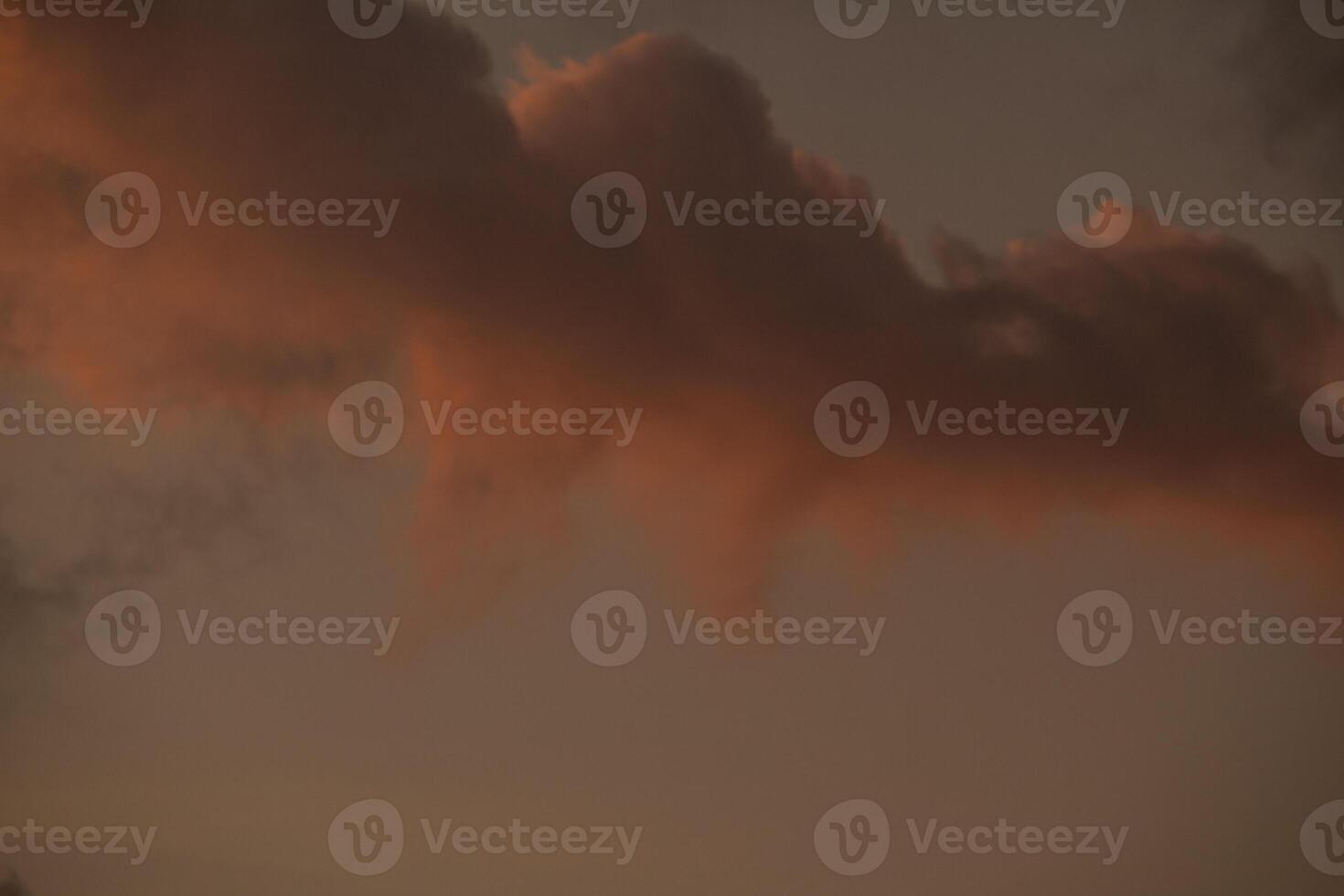 orange sky at dusk with cloud silhouettes photo