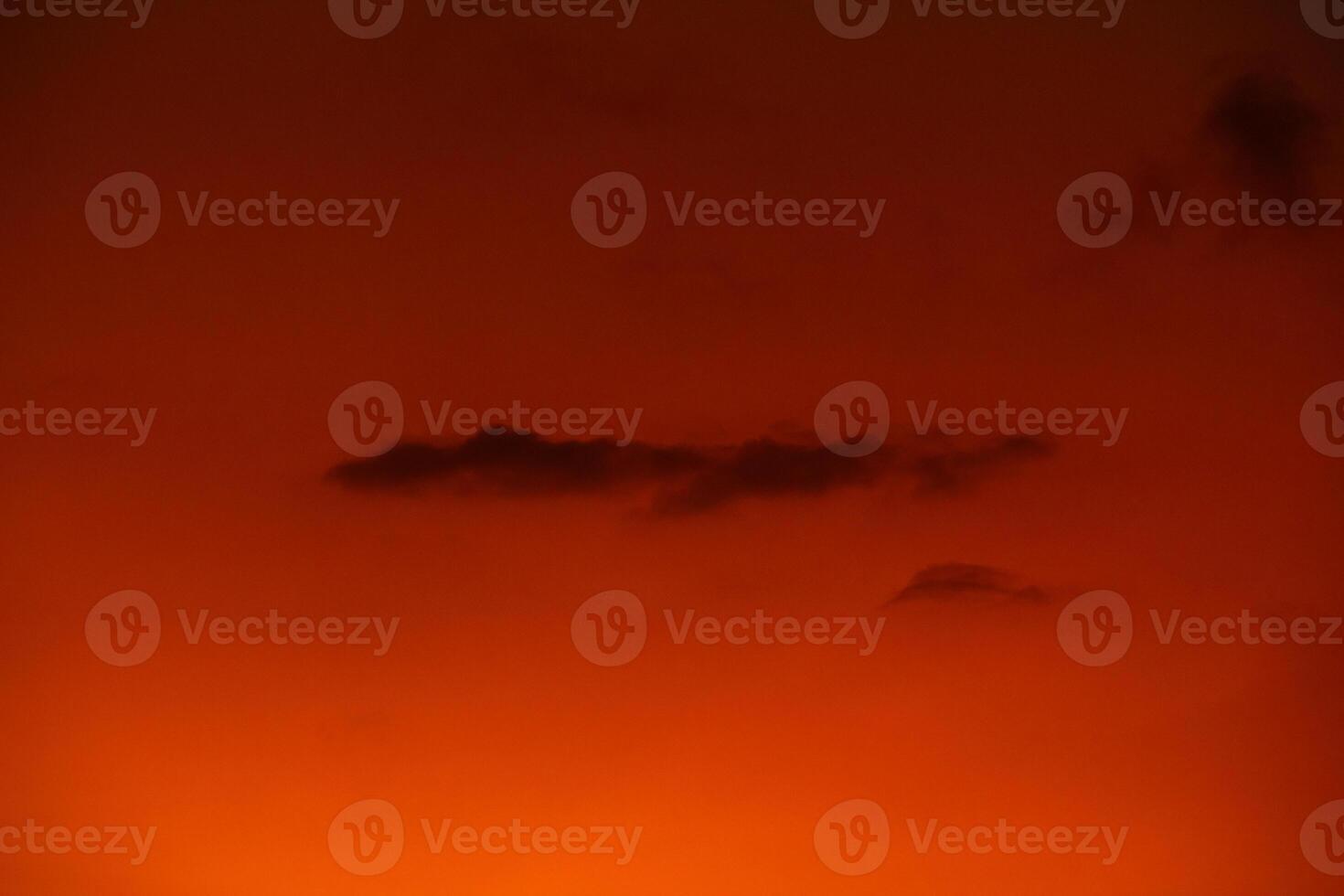 orange sky at dusk with cloud silhouettes photo