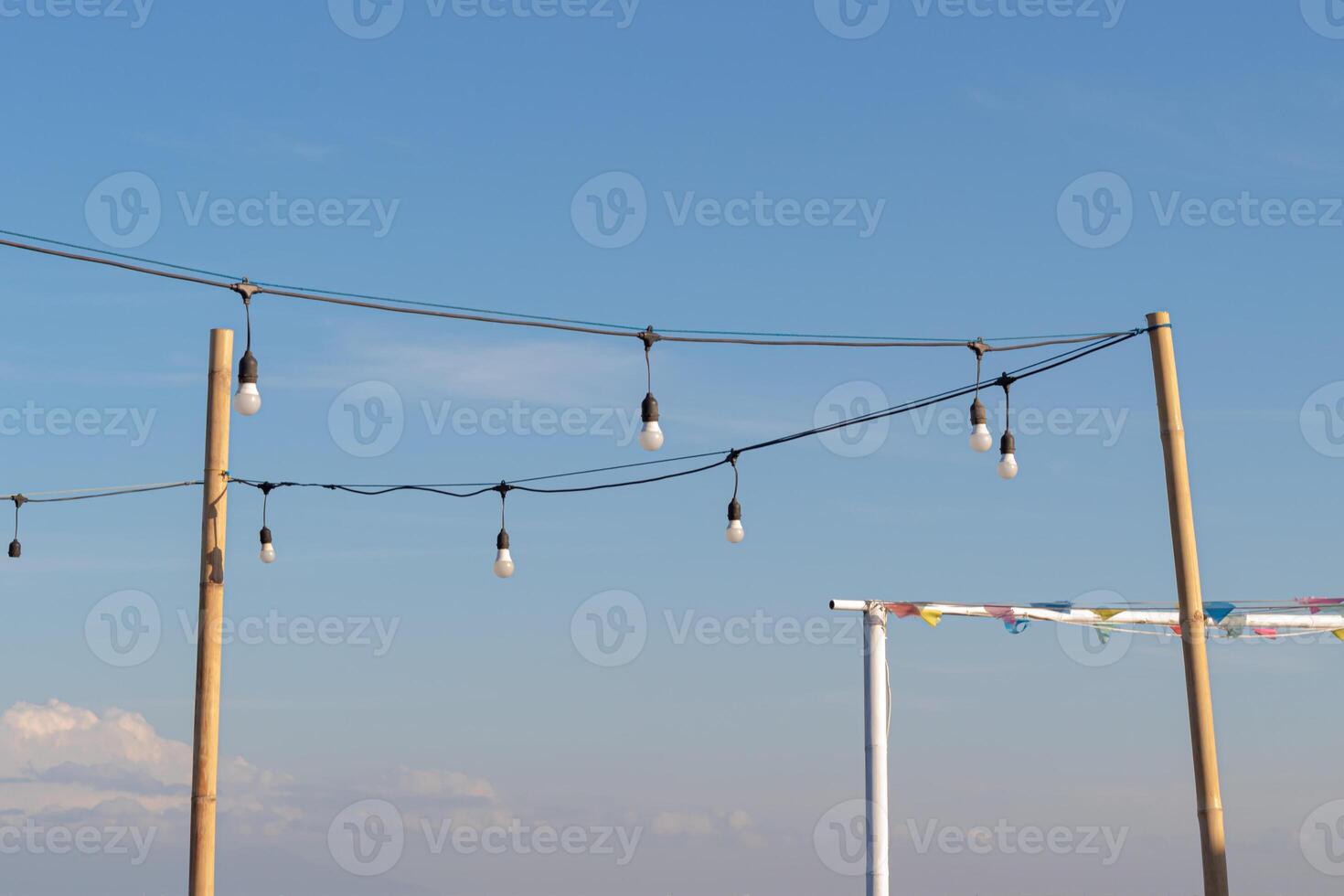 Light bulbs on a bright and slightly cloudy blue sky background photo