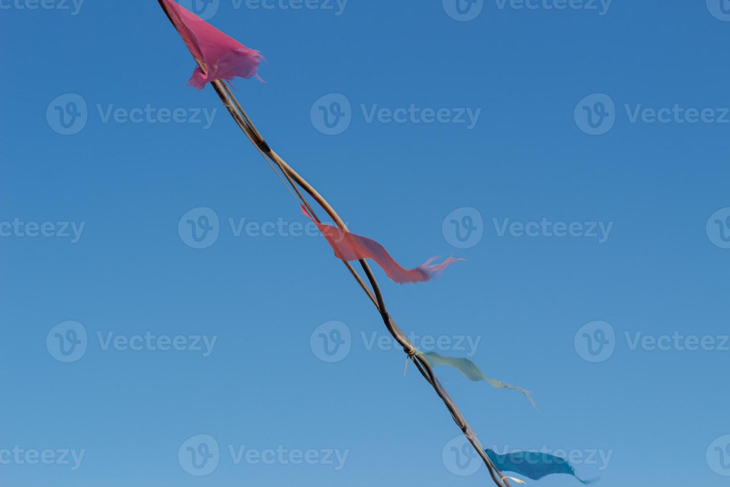 colorful triangle party flags on sky background for decoration photo