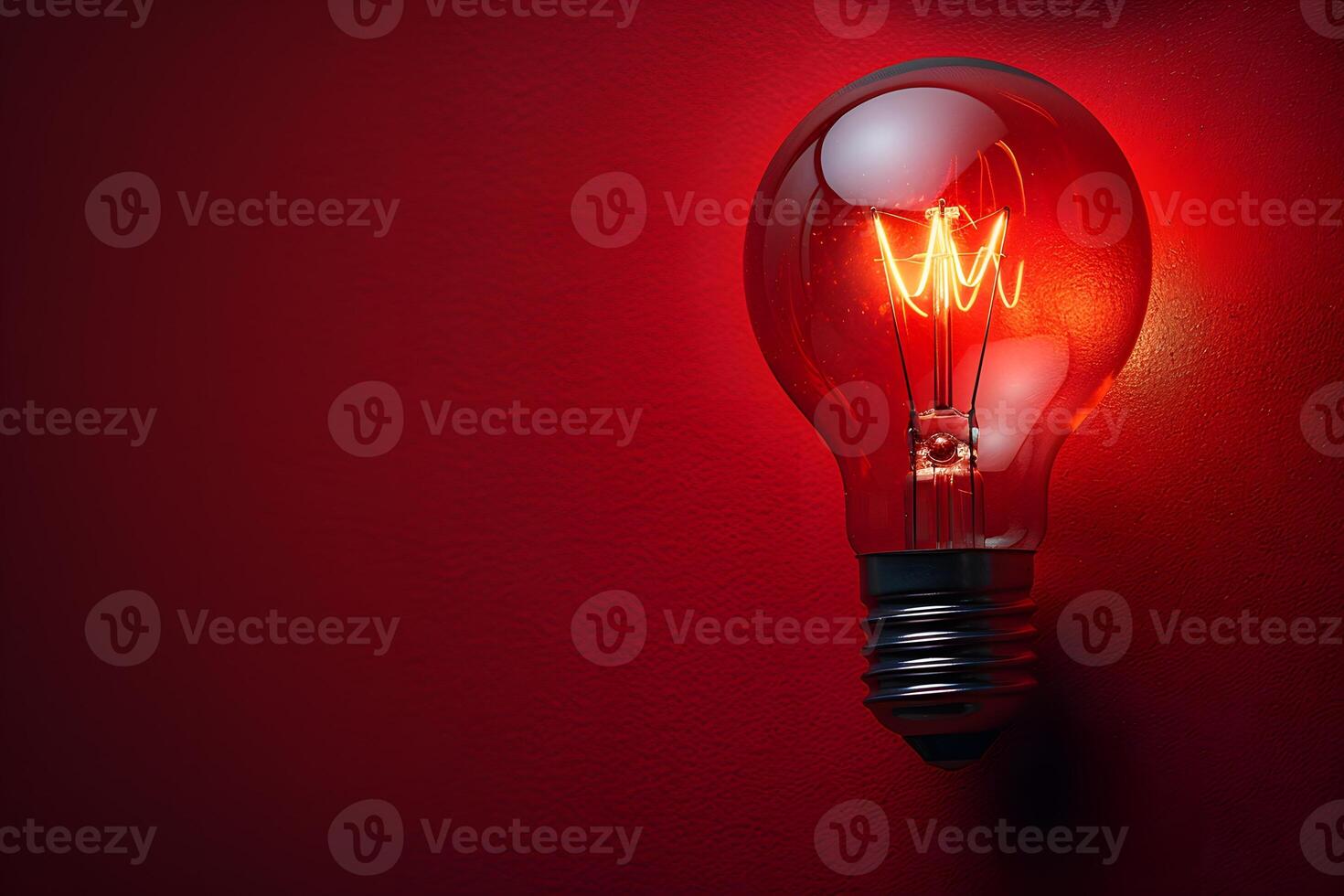 Vintage Edison Light Bulb Glowing Against Red Background - Retro Industrial Lighting for Decor and Design photo