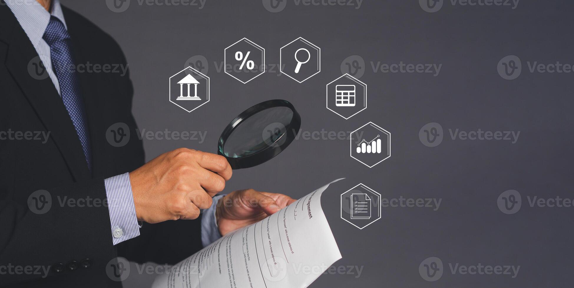 A businessman's holding a contract home property document while standing over gray background photo
