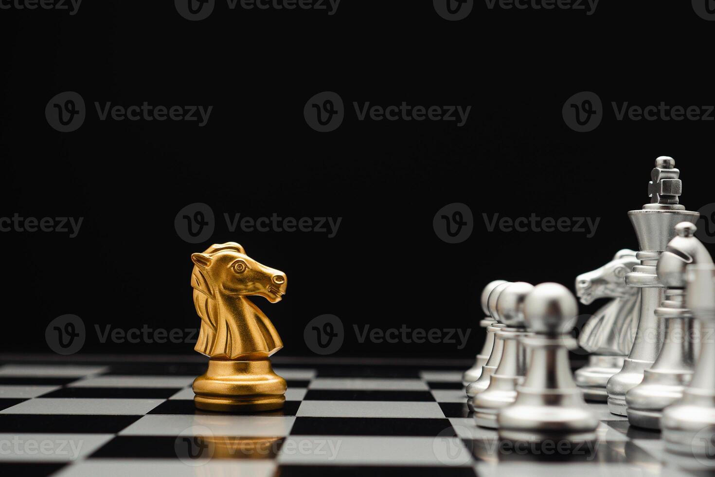 Chess pieces on board game planning and competition on black background photo