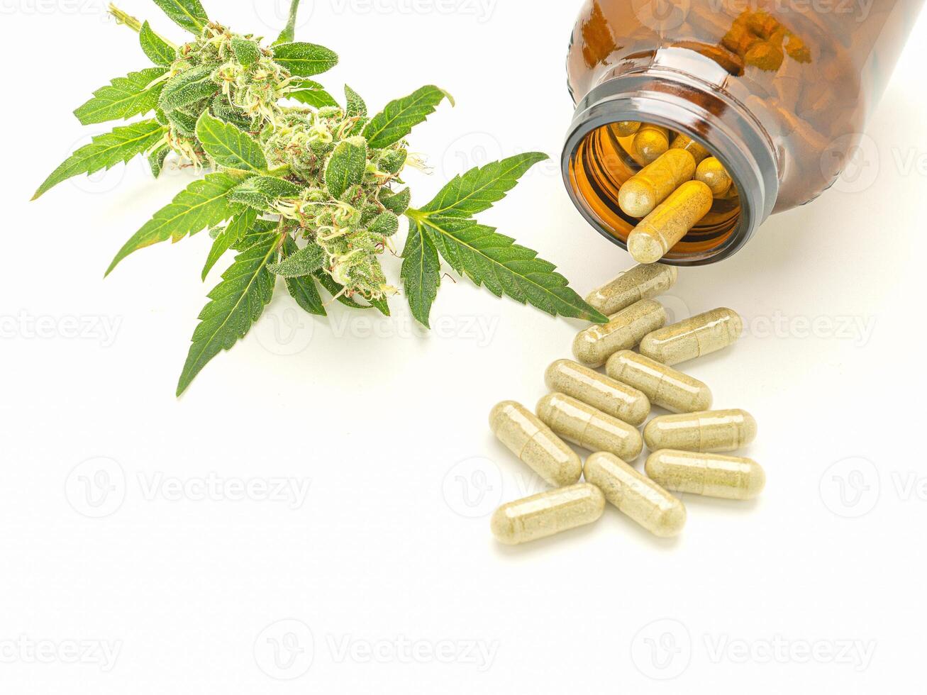 Top view of marijuana buds flower and pills are out of bottle isolated on a white background. Cannabis can help manage chronic pain, nausea, and vomiting resulting from chemotherapy treatment photo