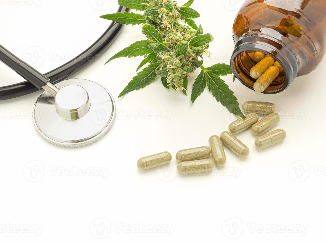 A stethoscope, cannabis buds flower, and pills are out of bottle isolated on a white background photo