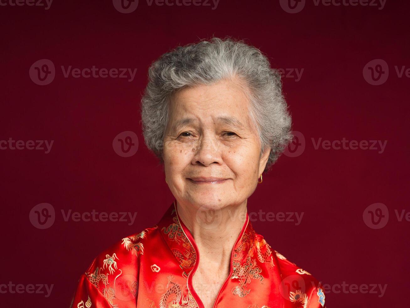Portrait of an elderly Asian woman wearing a traditional cheongsam qipao dress photo