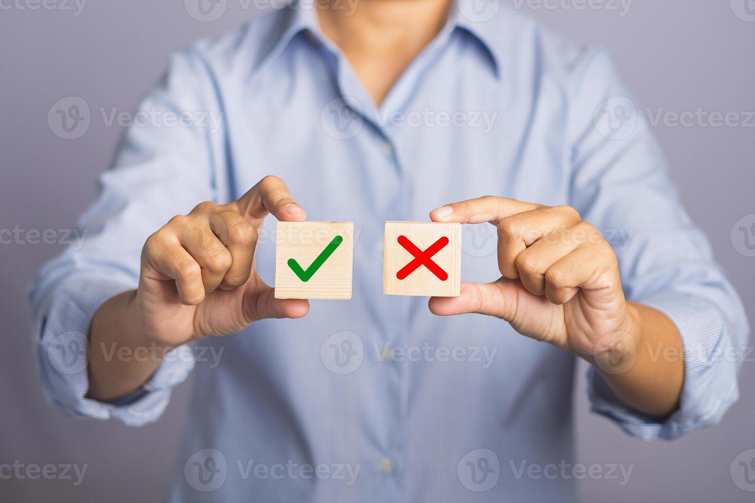 Choice Accept and Decline concept. Hand of holding two wooden cubes with text yes and no for choice while standing with gray background photo