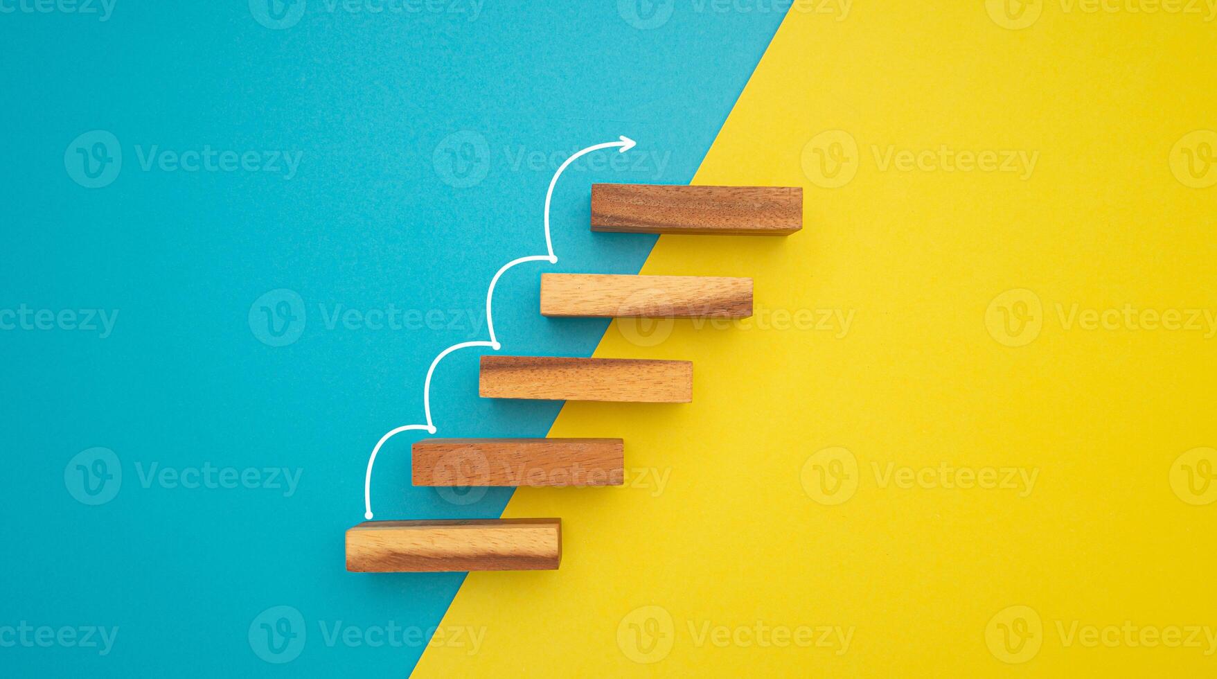 Business growth or increasing concept picture, the rising arrow on wooden blocks the staircase isolated on a blue and yellow background photo