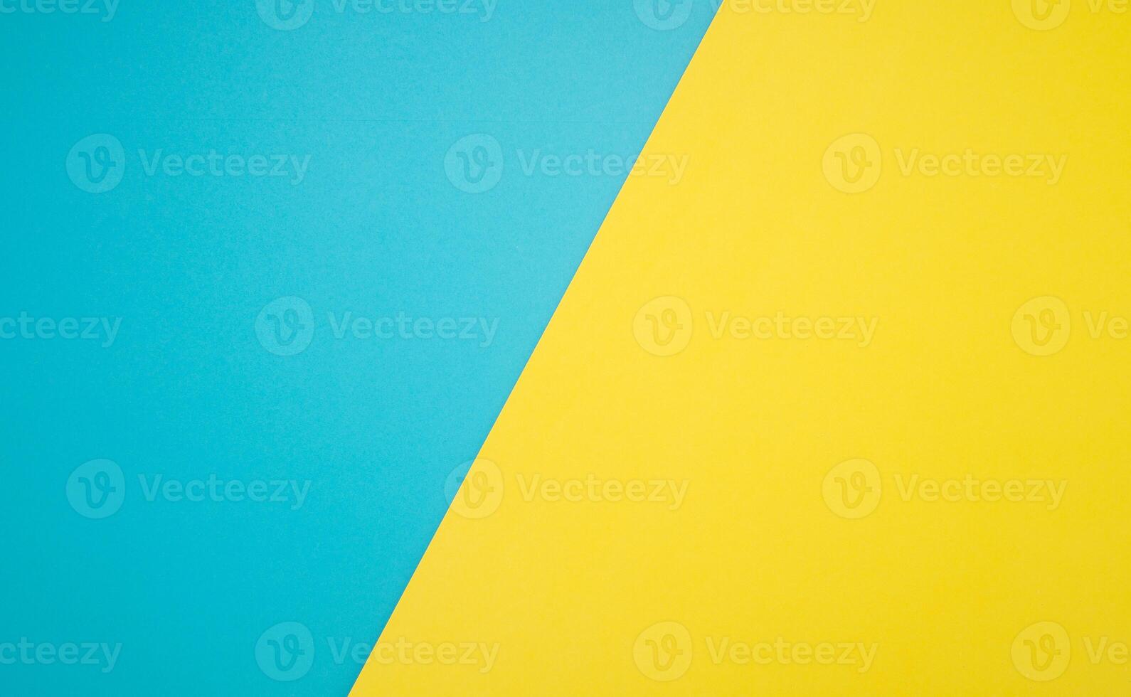 Top view of blue and yellow paper background with space for text photo