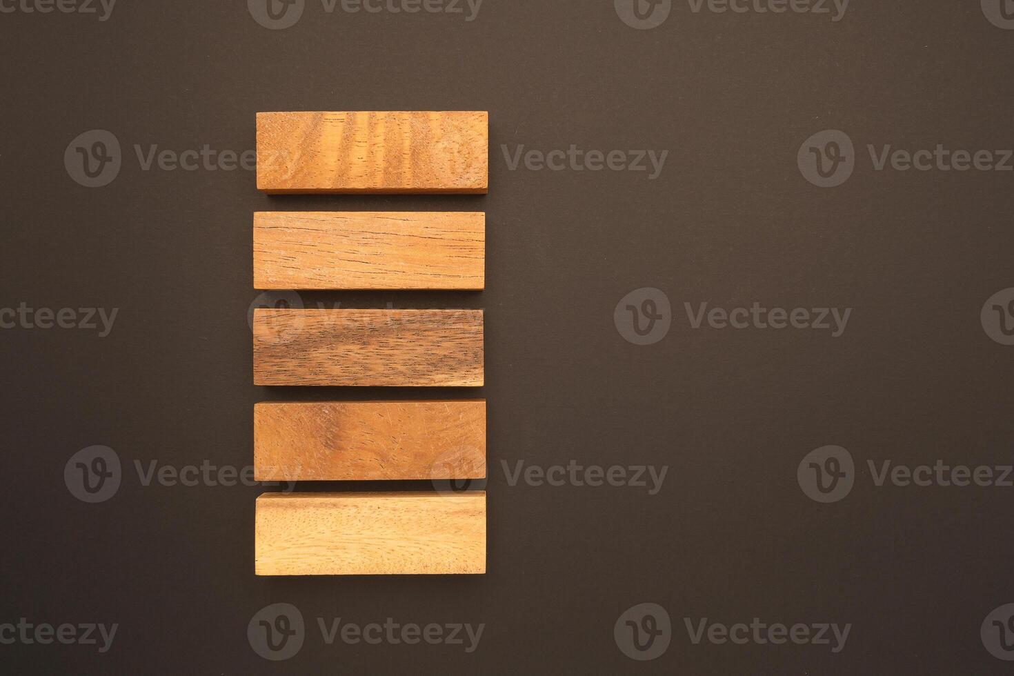 Top view of five empty wooden blocks isolated on a black background. Space for text photo