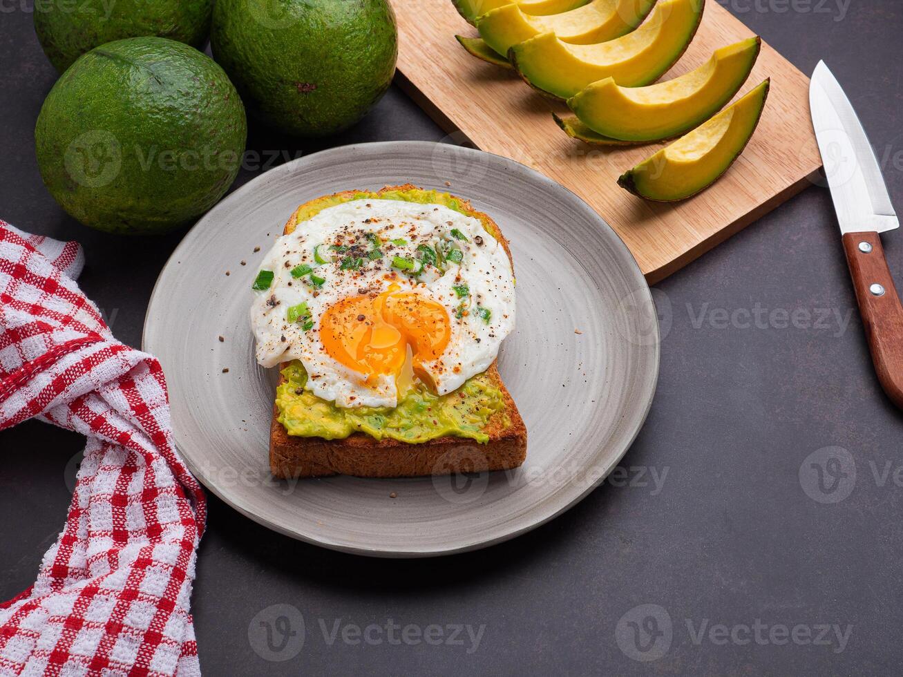 Toast with avocado and eggs served on a plate. Top view. Space for text. High vitamin fruit. Healthy fruit concept photo