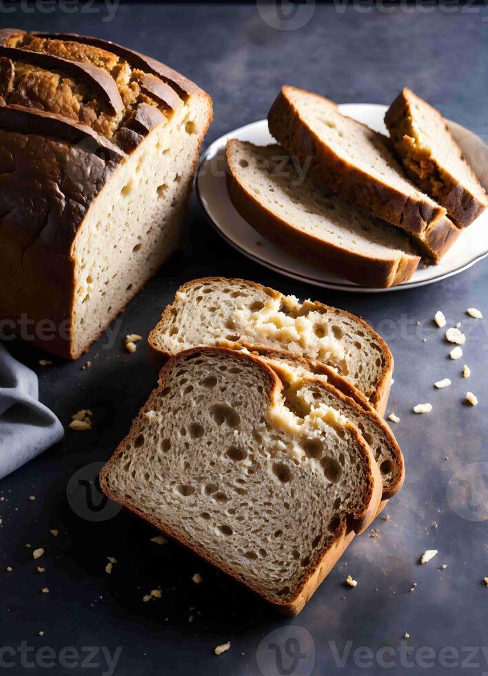 a loaf of bread with slices on a plate photo