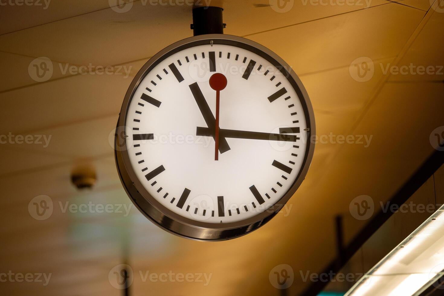Close-up of a street clock at a train station with a second hand photo