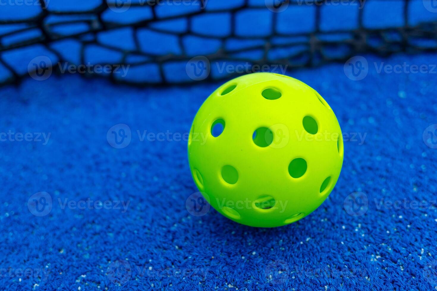 Ball of pickleball in front of the net, racket sports concept photo