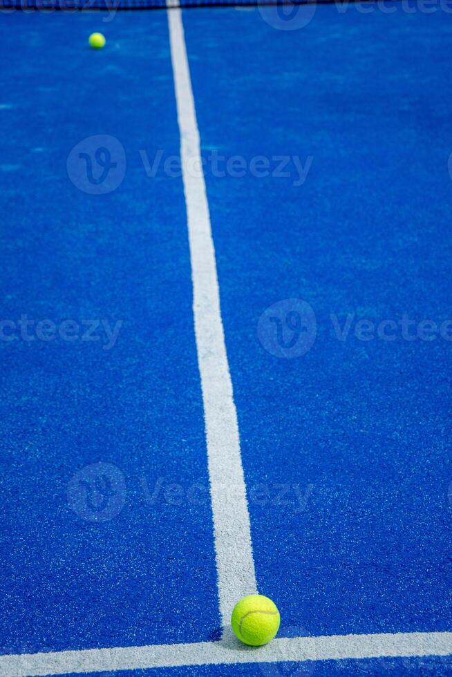 paddle tennis ball on the line of a blue paddle tennis court, concept of racket sports photo
