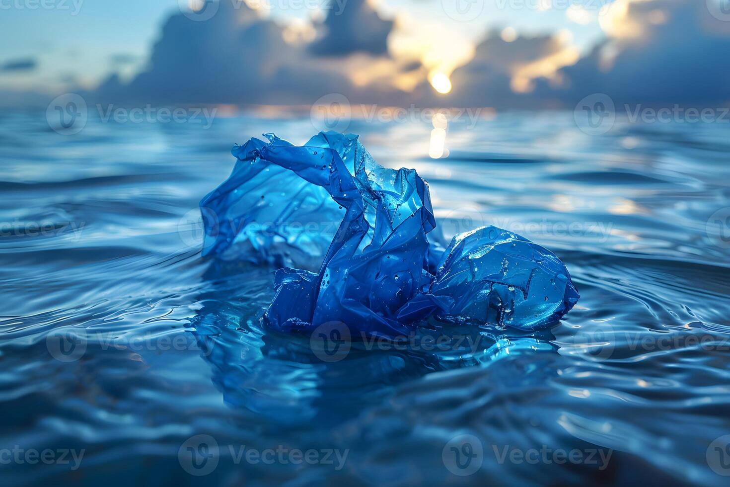 Environmental Pollution Concept Blue Plastic Bag in Ocean at Sunset photo