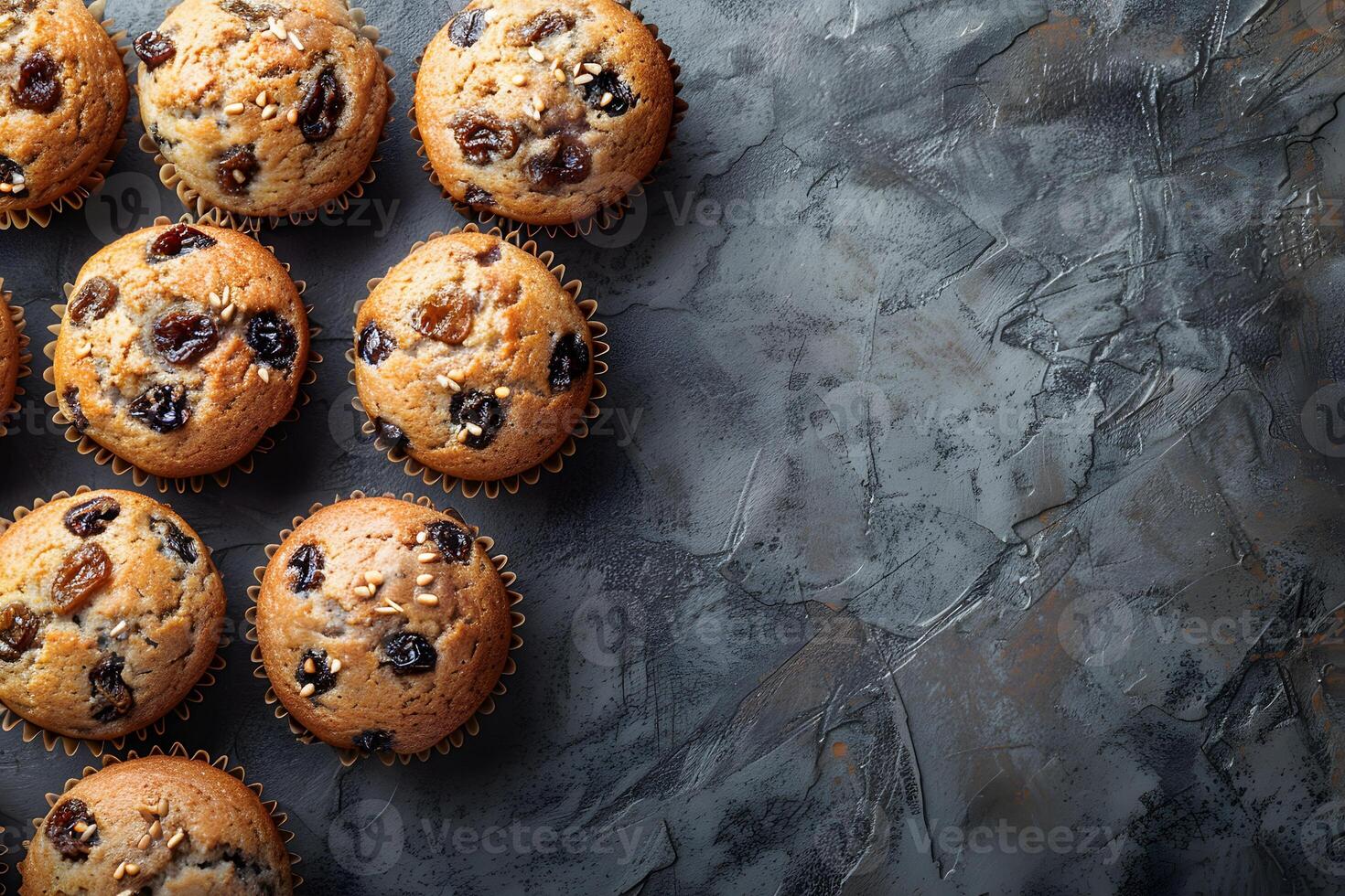 Delicious Muffins with Raisins on Rustic Gray Background - Ideal for Baking, Recipe Design, and Food Blog Graphics photo