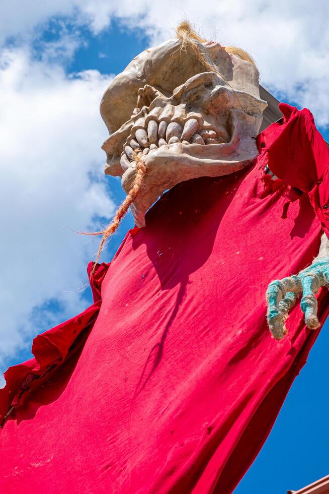 Giant decorative statue of a skull with red clothes during the celebration of the Sexta 13, Noite das Bruxas event. Montalegre, Portugal. photo